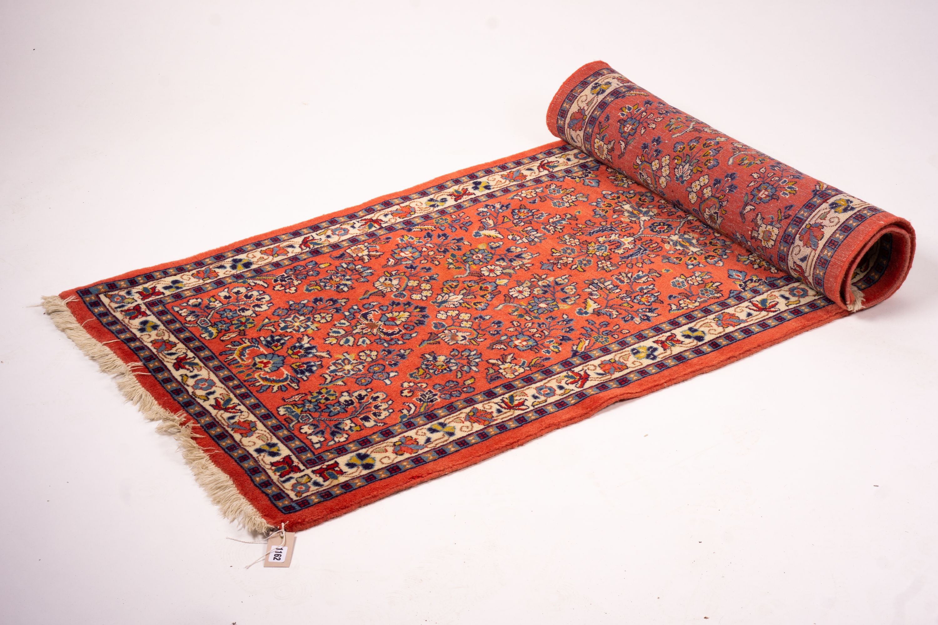 A Persian red ground runner, 202 x 83cm